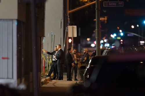 Investigators gather at a scene where a shooting took place in Monterey Park, Calif., Sunday, Jan. 22, 2023. Dozens of police officers responded to reports of a shooting that occurred after a large Lunar New Year celebration in a community east of Los Angeles late Saturday. (AP Photo/Jae C. Hong)