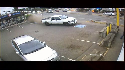 The white ute hurtled through the carpark of Donut Star. (Kiro 7)