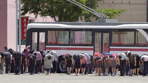 Pyongyang residents bow in memory of Kim Il-Sung on the 25th anniversary of his death.