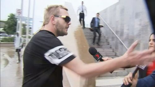 A supporter of Lewis clashed with media outside court. Picture: 9NEWS