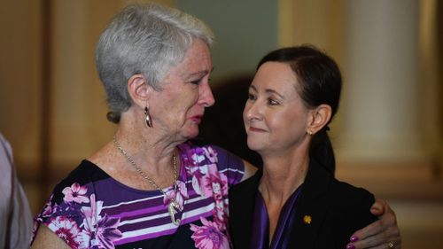 Jo Grant's mother Sandra Kelly (left) embraces Queensland Attorney General Y'vette D'Ath during a press conference at Parliament House. (Image: AAP)