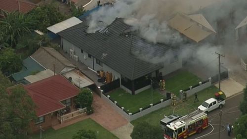 Emergency services were called to the house in Villawood about 3pm after reports of black smoke pouring from the building. (9NEWS)