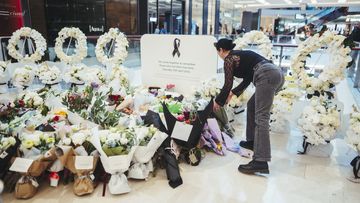 Members of the public pay their respects at the Westfield Bondi Junction shopping centre