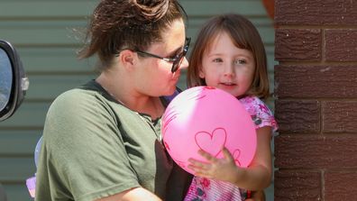 Cleo Smith is carried inside a friend&#x27;s house by her mother in Carnarvon.