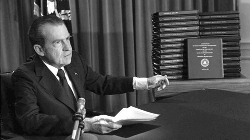 President Richard Nixon points to the transcripts of the White House tapes in 1974, after he announced on television that he would turn over the transcripts to House impeachment investigators. 