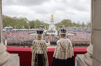 King Charles III and Queen Camilla watch the flypast from the balcony of Buckingham Palace after their Coronation on May 06, 2023 in London, England.
