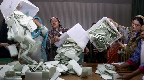 Pakistan election staff prepare to count ballots in Islamabad. (AAP)
