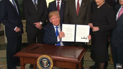 Donald Trump has signed a memorandum imposing up to $US60 billion ($77 billion) in tariffs on imports from China. (9NEWS)