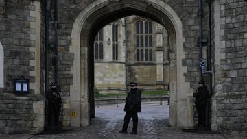 Police guard the Henry VIII gate at Windsor Castle at Windsor, England on Christmas Day, Saturday, Dec. 25, 2021. Britain&#x27;s Queen Elizabeth II has stayed at Windsor Castle instead of spending Christmas at her Sandringham estate due to the ongoing COVID-19 pandemic. (AP Photo/Alastair Grant)