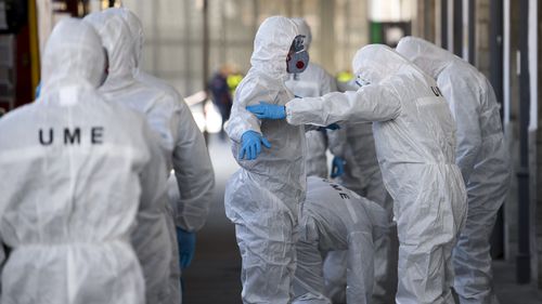 The Emergency Army Unit work in the train station in Granada, Spain Tuesday March 17, 2020.