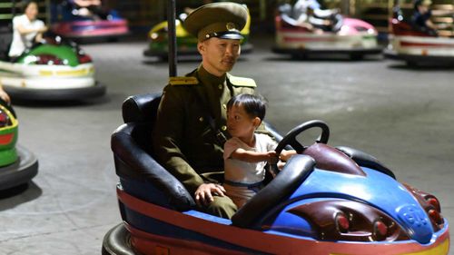 A North Korean military officer on the bumper cars at Kaeson. (Lesley Parker)