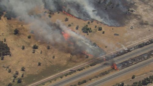Flames crossed a local freeway and raced toward homes, which forced residents to evacuate on Saturday after the blaze started near Patterson Road.