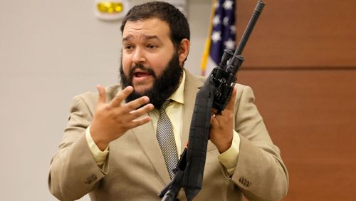 Broward County Sheriff's Office crime lab manger George Bello holds the weapon used by Marjory Stoneman Douglas High School shooter Nikolas Cruz