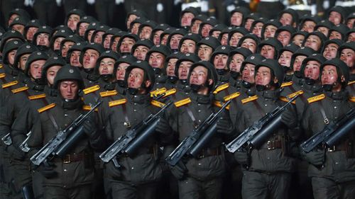 North Korean soldiers march in formation during a military parade.