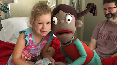 Emily with puppet in hospital