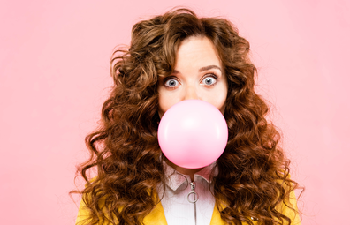 Woman blowing bubble gum