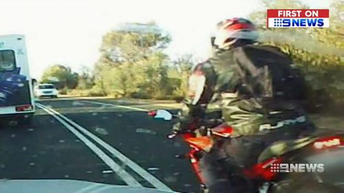 Vision has emerged showing a motorbike rider illegally overtaking vehicles twice within seconds. (9NEWS)