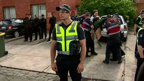 Yesterday, about 50 police officers moved in to evict people from the homes. (9NEWS)