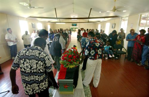 Palm Island locals pay tribute at the funeral of Mulrunji Doomagee in December 2004. (AAP)