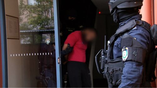 He was one of two arrested in early morning raids today. (9NEWS)