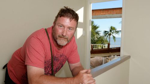 Mick Burrows surveys damage at the rented holiday home. (AAP)