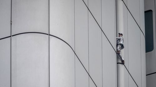 French urban climber Alain Robert, well known as "Spiderman", climbs up the Deutsche Bahn high-rise in central Frankfurt, Germany, Thursday, October 1, 2020