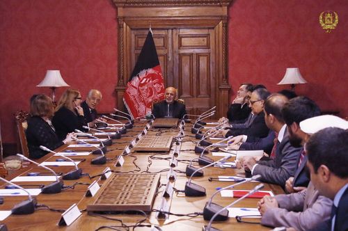 Afghan President Ashraf Ghani, center, speaks to U.S. peace envoy Zalmay Khalilzad, third left, at the presidential palace in Kabul. 