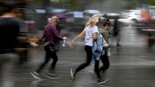 Some missed the memo as they ran for cover through Sydney's CBD. (AAP)