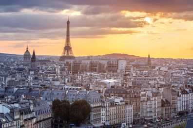 View of Paris in light of sunset with Eiffel tower silhouette against colorful sky