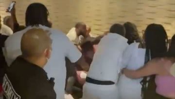 Security tries in vain to break up a brawl on a cruise ship.