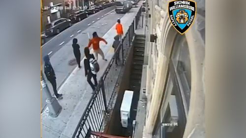 A boy is shown hurling the metal rod into the window of the synagogue after his friend hands it to him.