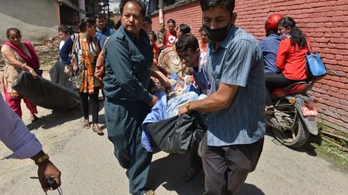 Patients carried out of a hospital in Kathmandu. (Getty)