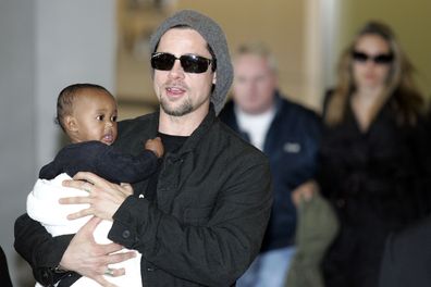 Brad Pitt followed by actress Angela Jolie arrive at the New Tokyo International Airport on November 27, 2005 in Narita, Japan. They are in Japan to promote a film "Mr. and Mrs. Smith". 