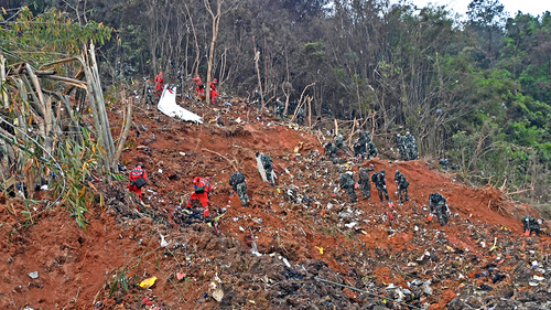 Rescue workers search for the black boxes at a plane crash site in Tengxian county, southwestern China's Guangxi Zhuang Autonomous Region, March 22, 2022.