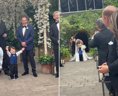 Little boy runs towards mum walking down the isle. 