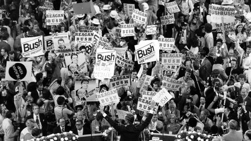 George H.W. Bush, centre , acknowledges the crowd before speaking to the Republican Convention delegates in Detroit, Mich.on July 16, 1980. Bush died at the age of 94 