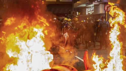 Bins are set on fire by anti-extradition bill protesters during a rally in Causeway Bay, Hong Kong.