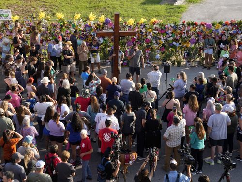 People gather for a vigil for flood victims in Kerrville, Texas. 