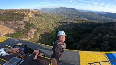 Strapped in with harnesses on top the Scenic Skyway roof, suspended 270 metres above Jamison Valley