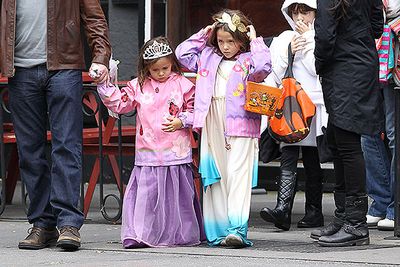Looking pretty in pink, Isabella and Gia Damon are led around the West Village of New York City on a trick-or-treat tour by their dad, Matt Damon, and mum Luciana Barroso.