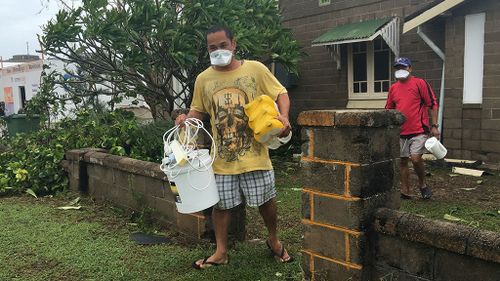 ‘It will kill me’: Devastated Bowen resident packs up his possessions in asbestos mask