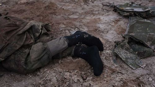 The feet of a Russian soldier killed in the early days of the invasion of Ukraine.