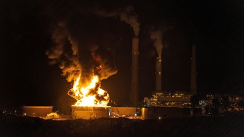 An oil tank is on fire near the town of Ashkelon, Israel, after it was hit by a rocket fire from the Gaza Strip.