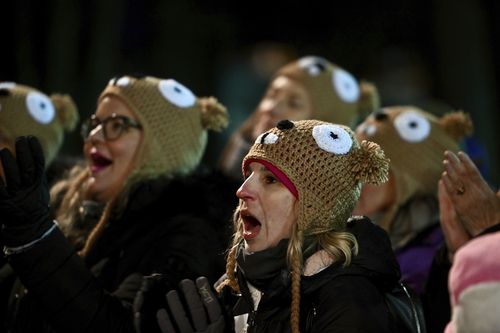 Ashley Johnson of Dallas watches entertainment while waiting for Punxsutawney Phil, the weather prognosticating groundhog, to come out and make his prediction during the 136th celebration of Groundhog Day on Gobbler's Knob in Punxsutawney, Pa., Wednesday, Feb. 2, 2022.