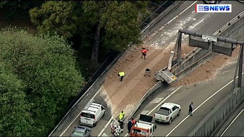 The truck spilled its load as it tipped. (9NEWS)