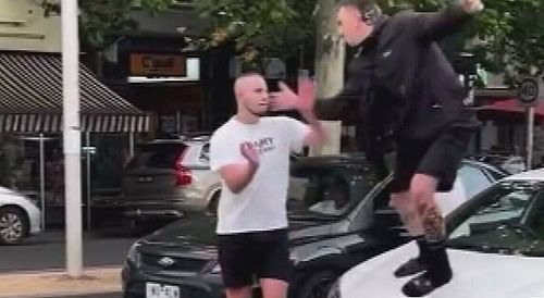 Footage has emerged of two men trading blows in the middle of a busy Melbourne bringing traffic to a standstill.The three men can be seen brawling in the middle of a busy intersection in Carlton, close to the CBD. 