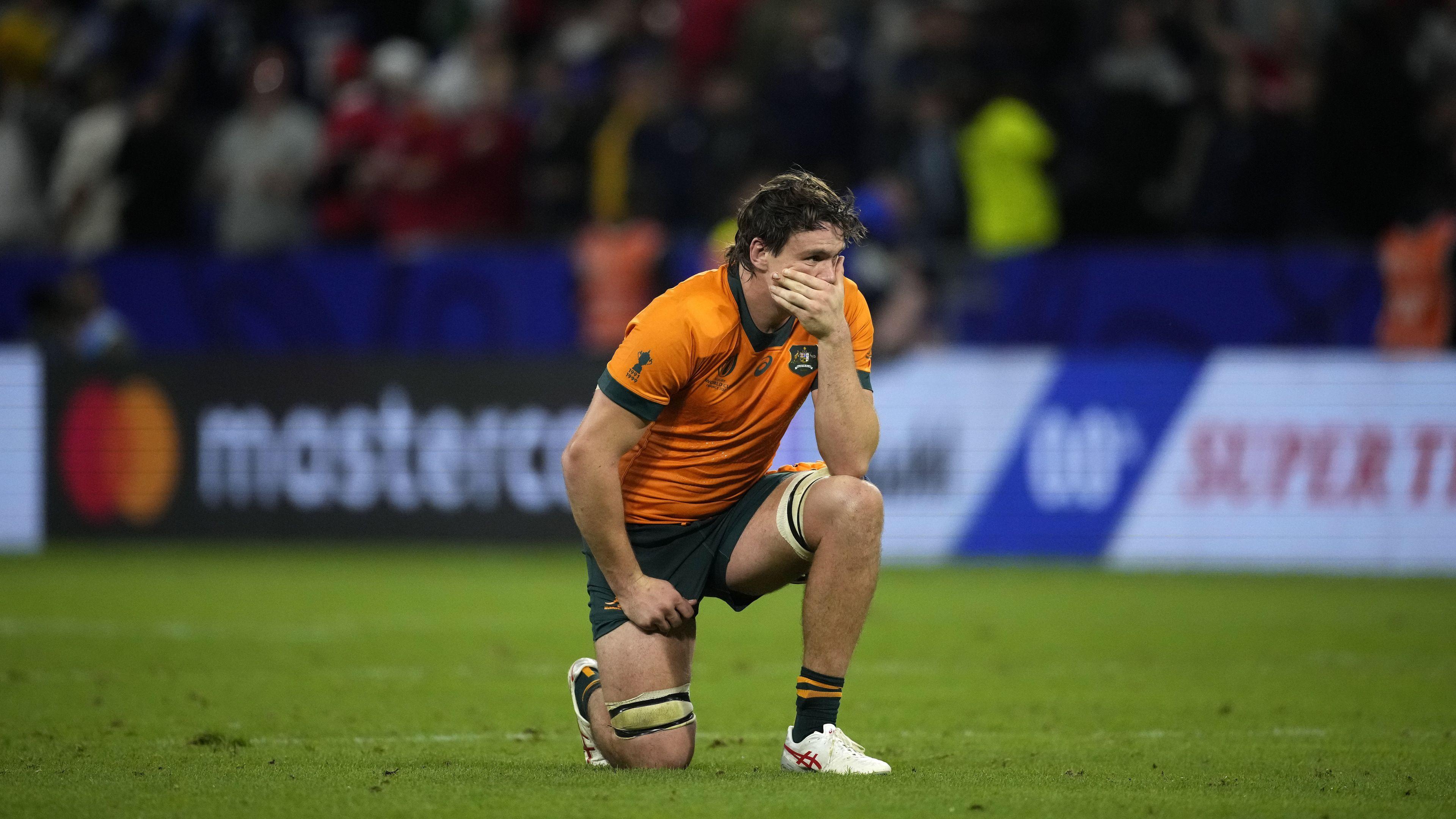 Australia&#x27;s Tom Hooper drops to his knee after being defeated by Wales.