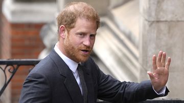 Prince Harry salutes media as he arrives at the Royal Courts Of Justice in London, Thursday, March 30, 2023.