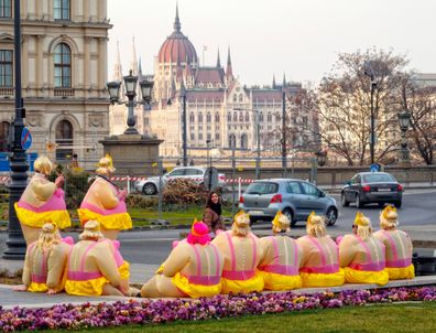Members of a bachelor party have a short rest on Adam Clark Square - Budapest, Hungary