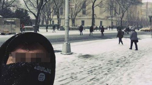 A man in an ISIS-branded scarf poses outside New York's Metropolitan Museum of Art.